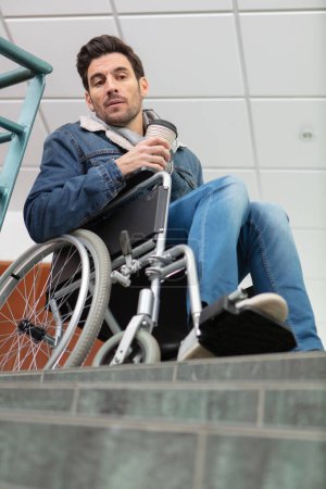 disabled man wondering how he will overcome this obstacle