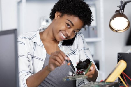 happy young woman fixing a pc