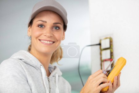 female electrician checking a socket