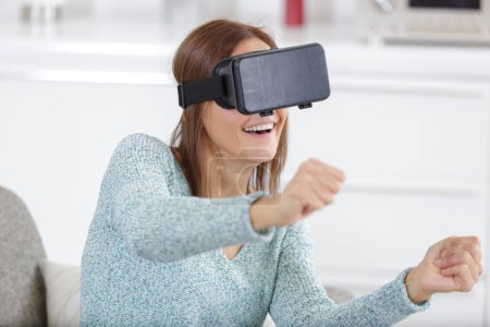 woman having fun with vr headset at home