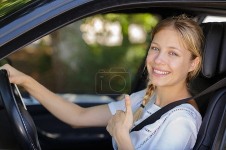 young blond woman showing thumbs up