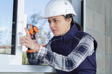 female window fitter using cordless screwdriver