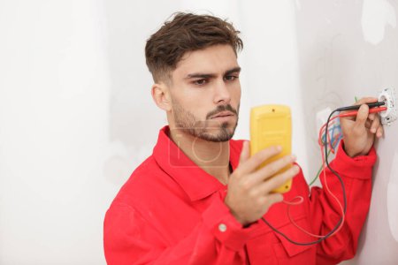 an electrician measuring the voltage