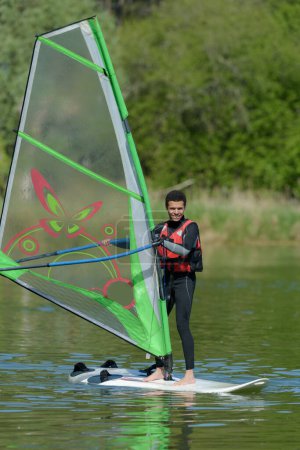 a man is doing windsurf