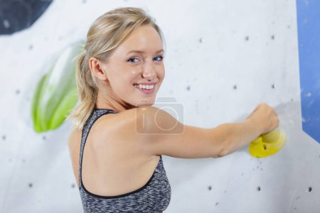 female climber on rock climbing wall