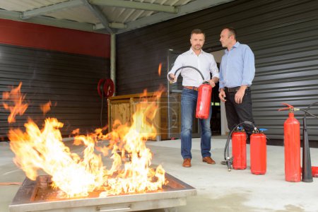 two men testing the fire extinguisher