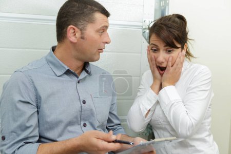 woman shocked and surprised with the bills