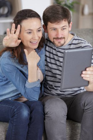 couple waving during a video chat