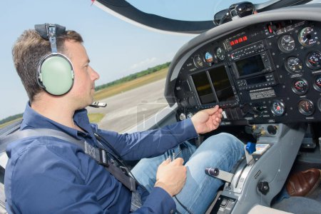 a pilot operating cockpit controls
