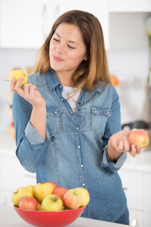 woman looking adoringly at an apple