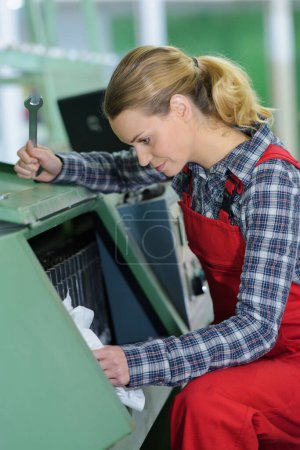 woman operating a machine with tools