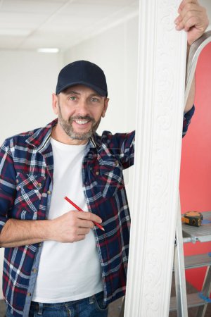 man working with plaster on a wall at home