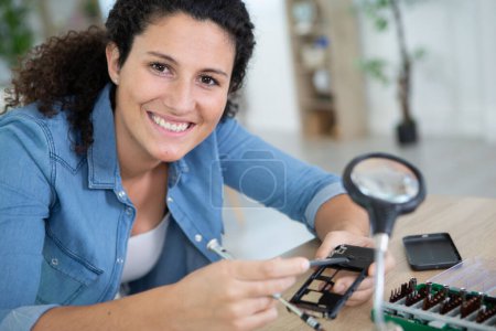 women technician fixing mobile phone repair and maintenance services