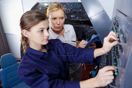 aircraft aviation training supervisor observing apprentice