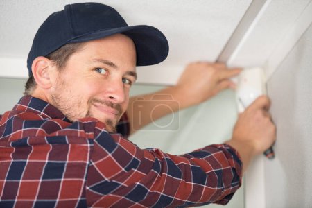 happy man installing security system