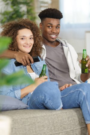 picture of sweet couple posing holding beer bottle