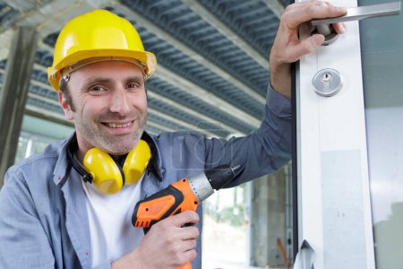 happy builder worker with pneumatic hammer drill