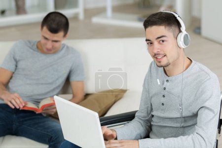 two young men studying at home