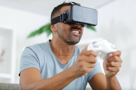 young man playing with virtual reality glasses