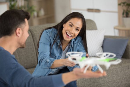 young couple playing with a small drone