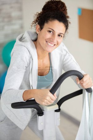 home fitness workout woman training on smart stationary bike i