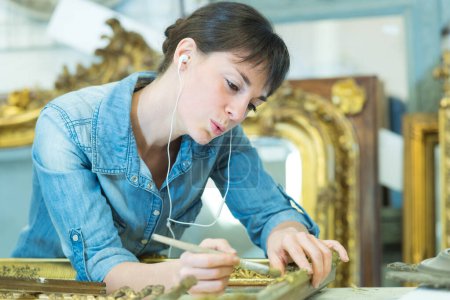 antique frame collector cleaning the embellishment