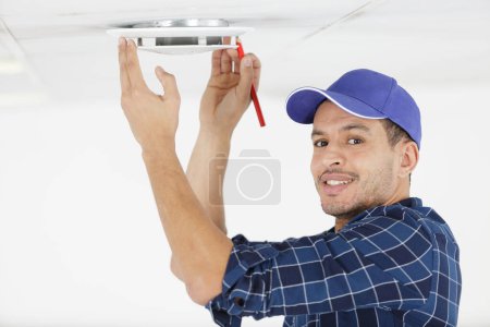 a man making ceiling measurements