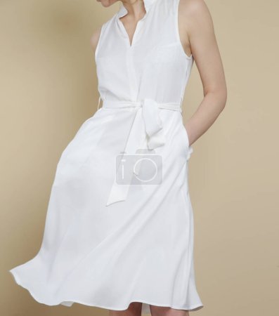 Series of studio photos of young female model in white midi dress