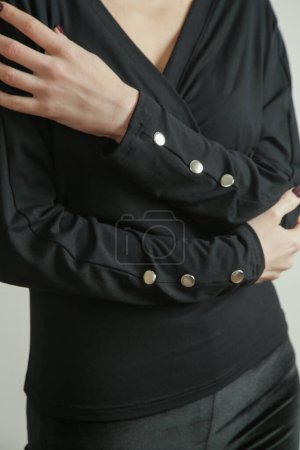 Photo for Studio photo of young female model wearing black cotton shirt with buttons on sleeves. - Royalty Free Image
