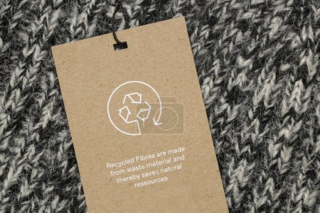 Photo for Close up of clothing tag with recycle icon. Recycling products concept. Zero waste, suistainale production, environment care and reuse concept. - Royalty Free Image