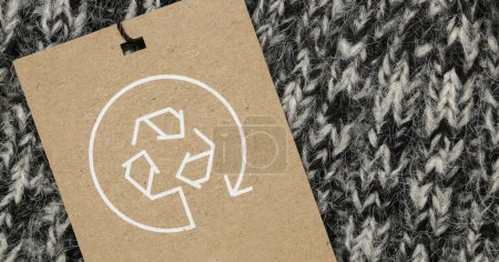 Photo for Close up of clothing tag with recycle icon. Recycling products concept. Zero waste, suistainale production, environment care and reuse concept. - Royalty Free Image