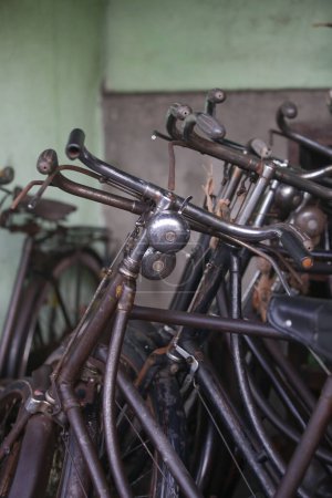 Photo for Stack of vintage rusty bicycles in the workshop - Royalty Free Image