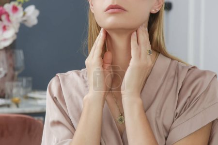 Photo for Caucasian woman touching her throat. Sore throat, cold, flu, tonsillitis or thyroid gland problem - Royalty Free Image