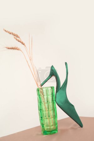 Creative studio shot of green satin slingbacks heels with the classy pointed toe, product photography