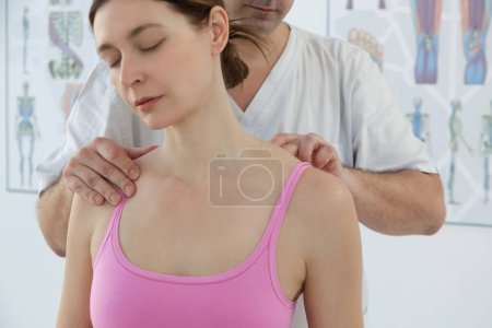 Photo for Woman at the doctors office on chiropractic, physiotherapy or myodynamic treatment to treat and prevent musculoskeletal problems, reduce pain and muscle tension. - Royalty Free Image