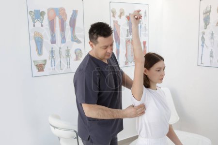 Photo for Woman at the doctors office on chiropractic, physiotherapy or myodynamic treatment to treat and prevent musculoskeletal problems, reduce pain and muscle tension. - Royalty Free Image
