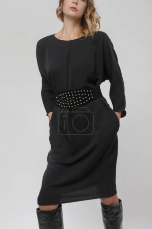 Serie of studio photos of young female model in timeless black dress