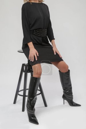 Serie von Studiofotos junger Models in zeitlosem schwarzen Kleid