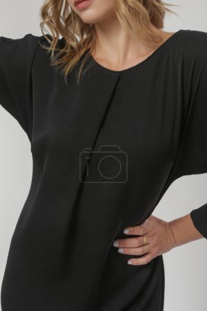 Serie of studio photos of young female model in timeless black dress