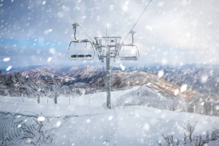 Photo for Cable car atop the snow-capped Deogyusan mountains at deogyusan national parkon a snowy day near Muju, South Korea. - Royalty Free Image