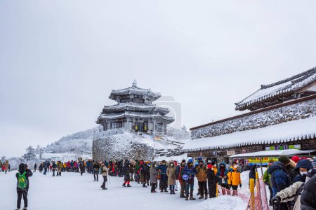 Photo for Muju-gun, Jeollabuk-do, Korea - January 10 2021: Tourists atop Deogyusan Mountain at Deogyusan National Park on a snowy day near Muju, South Korea - Royalty Free Image