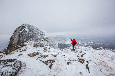 Photo for Tourists atop Deogyusan Mountain at Deogyusan National Park on a snowy day near Muju, South Korea - Royalty Free Image