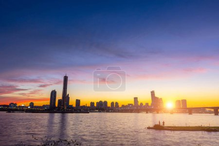 Photo for Seoul city Skyscrapers at night along the Hangang River after sunset at twilight and the sky with beautiful colors at yeouido, south Korea. - Royalty Free Image
