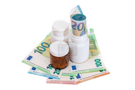 Photo for Different Bottles with Pills, Capsules and Medicines on the Euro Banknotes - Isolated on White. Global Pharmaceutical Industry and Big Pharma. Euro Money Bills - Isolation - Royalty Free Image