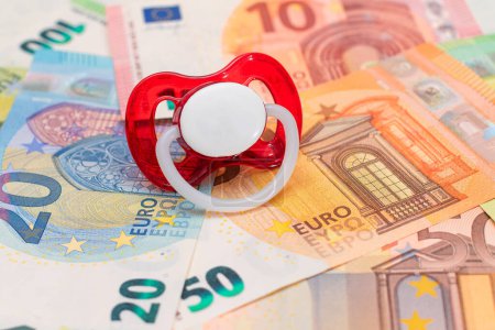 Photo for Childfree, Contraception and Birth Control Concept: Baby Pacifier on the Euro Banknotes. Having Children is Expensive and Unprofitable - Royalty Free Image