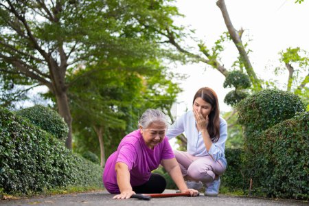 Photo for Asian senior woman fell down on lying floor because faint and limb weakness and Crying in pain form accident and her daughter came to help support. Concept of old elderly insurance and health care - Royalty Free Image