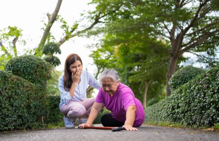 Photo for Asian senior woman fell down on lying floor because faint and limb weakness and Crying in pain form accident and her daughter came to help support. Concept of old elderly insurance and health care - Royalty Free Image