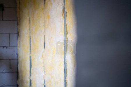 Photo for Unfinished additional frame wall in a private house. Bare walls without repair. Universal insulation and sound insulation - Royalty Free Image