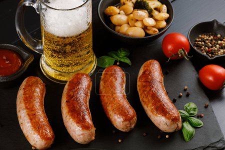 Photo for Sausages with beer. Fried anchovies and delicious food with beer. - Royalty Free Image