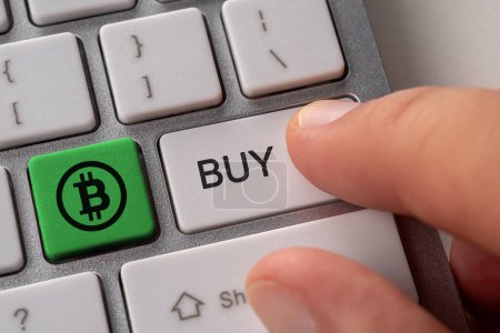 Photo for Buy bitcoin concept. Close up keyboard button choice of buying cryptocurrency bitcoin to get profit. - Royalty Free Image